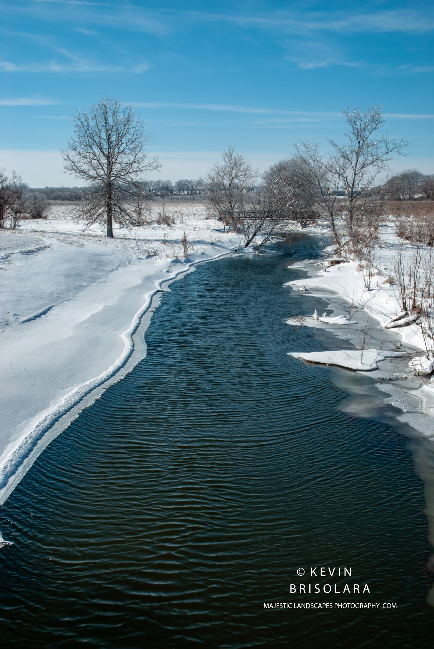 AN OVERNIGHT SNOWFALL AND FREEZING RAIN TAKE HOLD OF THIS PRAIRIE LANDSCAPE